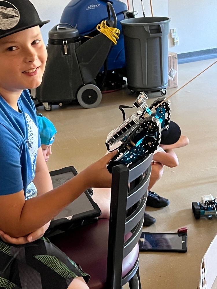 student holding his bot during the battle