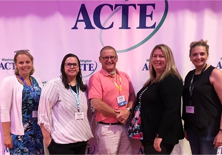 Staff standing together for a picture at the WA-ACTE conference .