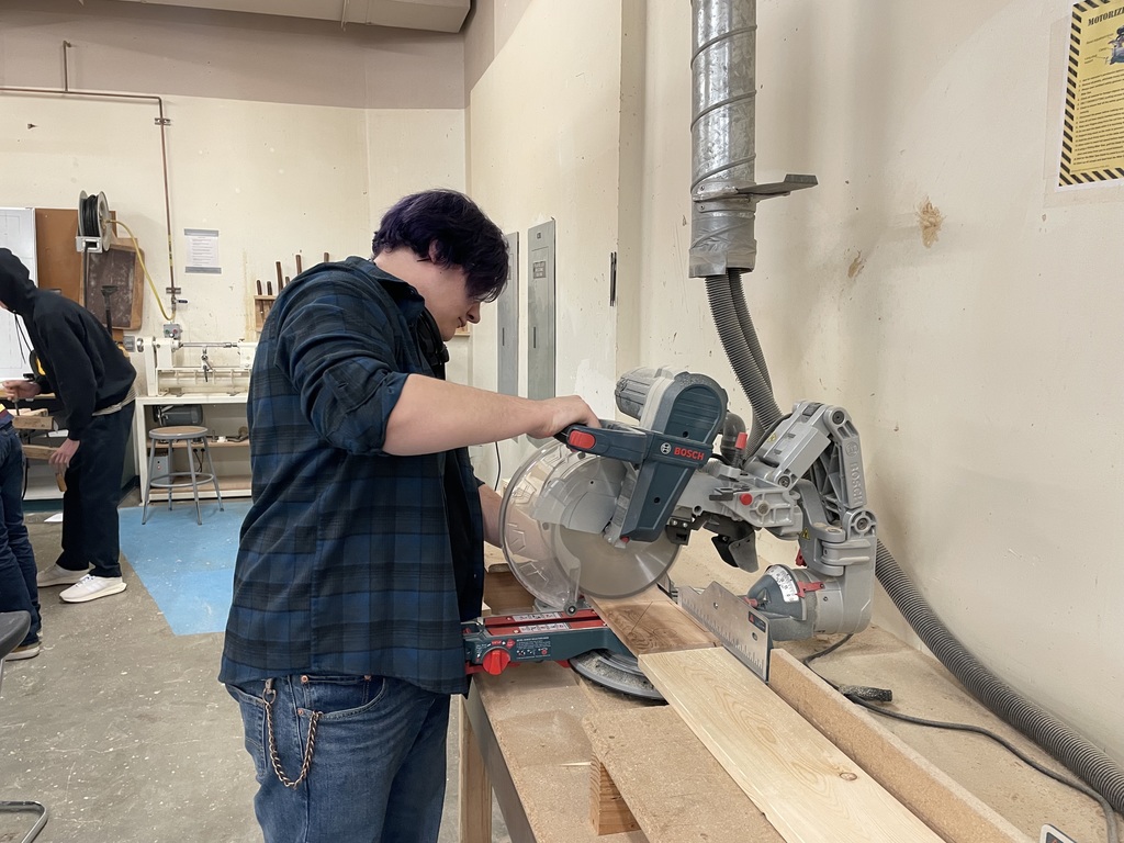 Shop student using a saw