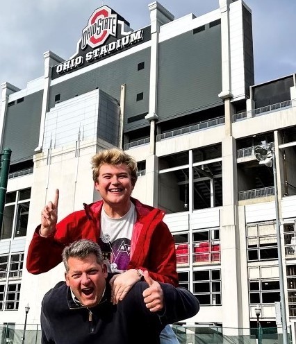 Eric Smith outside of Ohio Stadium at a game with his son